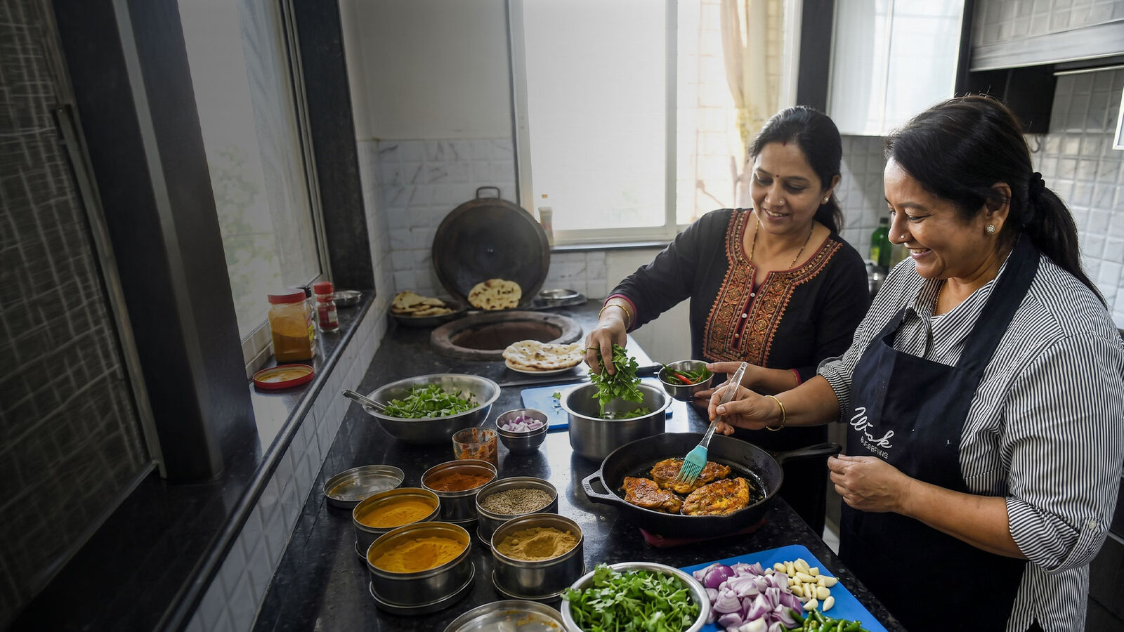 Verified cook and helper preparing a meal in an Indian home